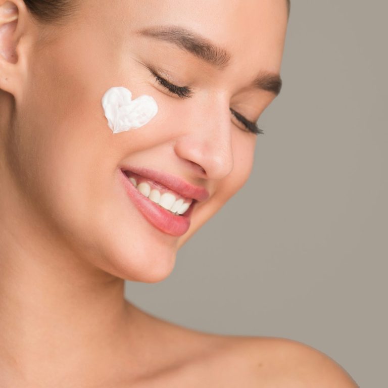 Anti wrinkle cream. Woman with cream in heart shape