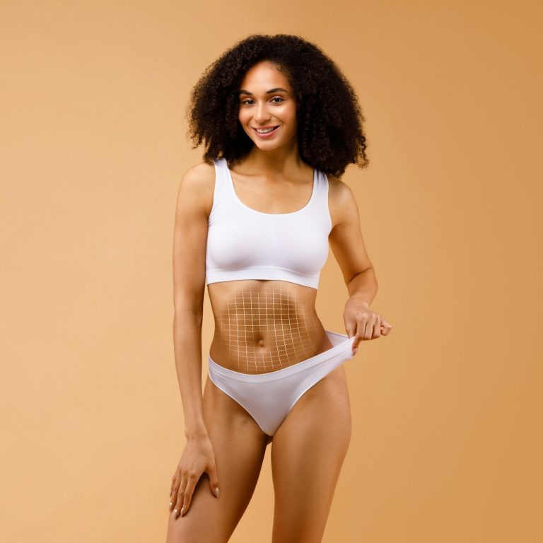 Slender black lady in underwear with net on her belly